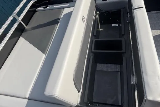 Slide: The Image of Sun Tracker Party Barge 22 RF DLX 2026 interior seating with storage compartments. - 23