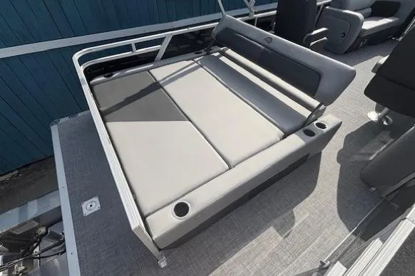 Slide: The Image of Sun Tracker Party Barge 22 RF DLX 2026, featuring spacious seating and cup holders. - 24