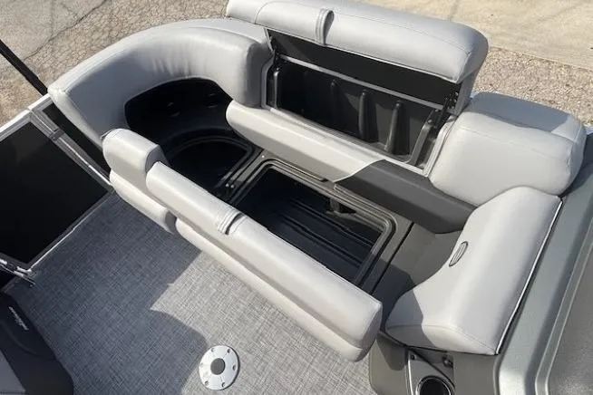 Slide: The Image of 2026 Sun Tracker Party Barge 22 RF DLX interior seating with storage compartments. - 9