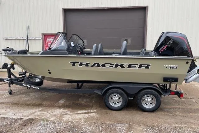 The Image of 2026 Tracker Targa V-19 Combo boat on trailer, parked outside a garage. - 0
