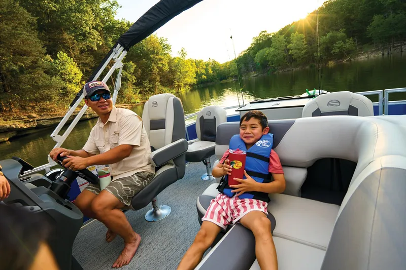 Slide: The Image of 2026 Sun Tracker Fishin' Barge 20 DLX pontoon boat with comfortable seating and canopy. - 18