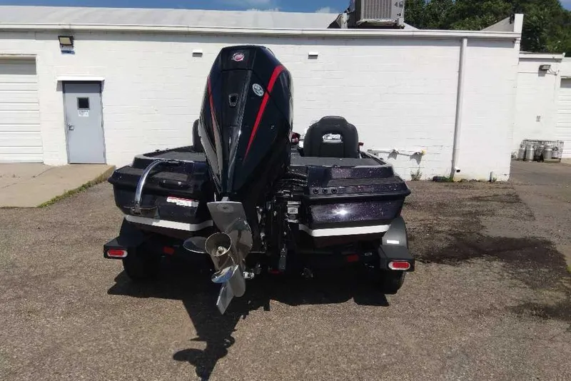 Slide: The Image of 2026 Nitro Z20 XL Pro boat, rear view, parked outside a white building. - 10