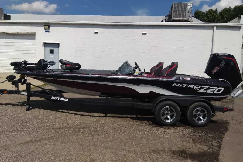 The Image of 2026 Nitro Z20 XL Pro boat on trailer, parked outdoors, showcasing sleek design and modern features. - 0