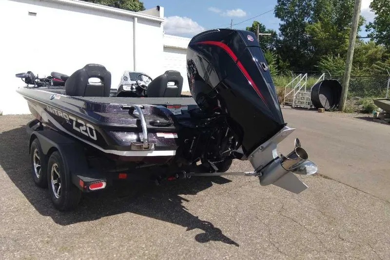 Slide: The Image of 2026 Nitro Z20 XL Pro boat with powerful outboard motor, parked outdoors. - 8