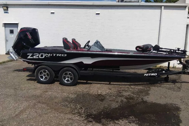 Slide: The Image of 2026 Nitro Z20 XL Pro boat on trailer, parked outdoors, side view. - 7