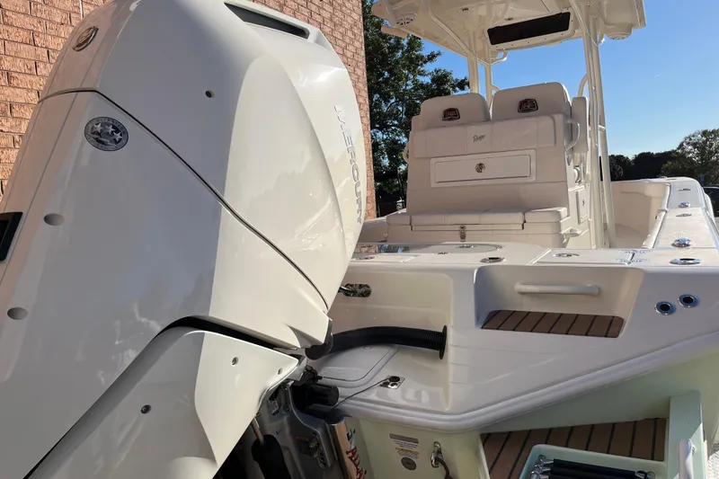 Slide: The Image of 2024 Ranger 2600 Bay boat with powerful outboard motor, sleek design, and spacious seating. - 5