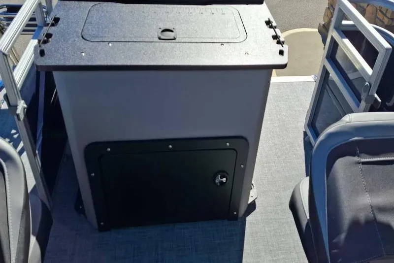 Slide: The Image of 2026 Sun Tracker SportFish 20 DLX boat interior with storage compartment and seating. - 79