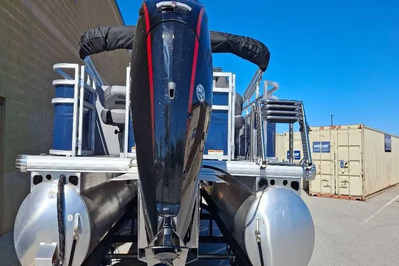 Slide: The Image of 2026 Sun Tracker SportFish 20 DLX pontoon boat with powerful outboard motor, docked outdoors. - 81