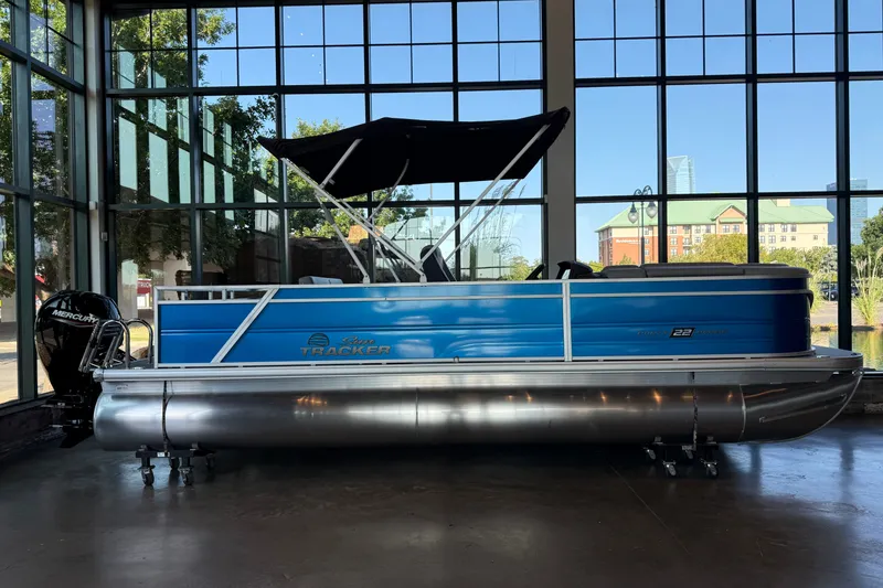 The Image of 2026 Sun Tracker Party Barge 22 RF DLX pontoon boat displayed indoors. - 0