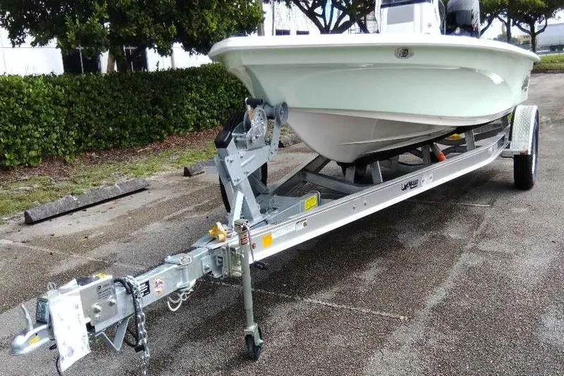 Slide: The Image of 2026 Mako 18 Pro Skiff on trailer, parked outdoors, ready for transport. - 2