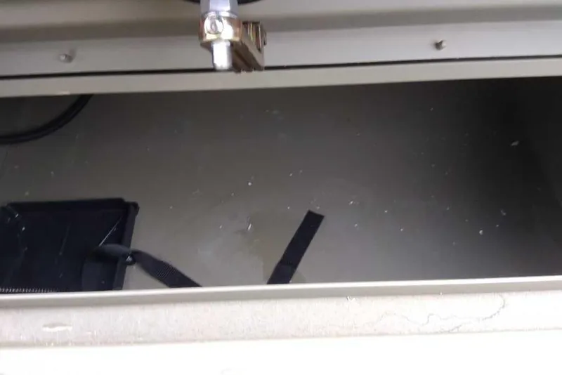 Slide: The Image of Storage compartment of 2026 Tracker Grizzly 1754 SC boat, featuring a latch and strap. - 35