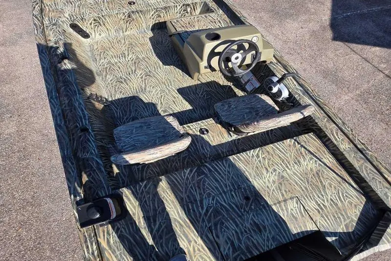 Slide: The Image of 2026 Tracker Grizzly 1754 SC boat with camouflage interior and steering console. - 3