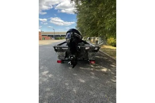 Slide: The Image of 2026 Tracker Grizzly 1654 T Sportsman boat on a trailer, parked outdoors. - 3