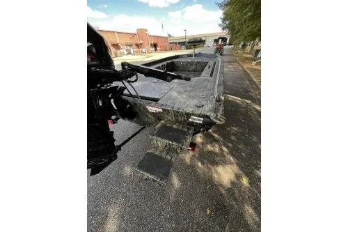 Slide: The Image of 2026 Tracker Grizzly 1654 T Sportsman boat on a paved surface, rear view. - 4