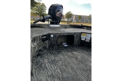 Slide: The Image of 2026 Tracker Grizzly 1654 T Sportsman boat interior with Mercury engine, camo design. - 6