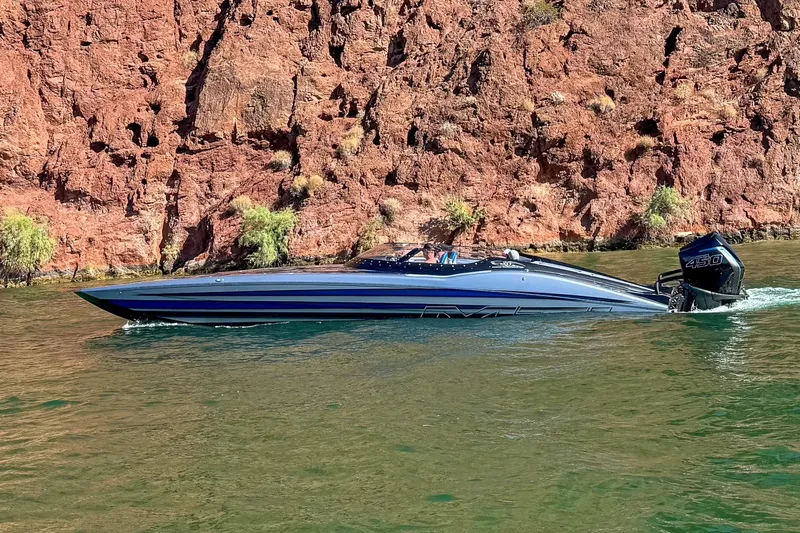 Slide: The Image of 2019 MTI 340X speedboat cruising near rocky shoreline. - 4