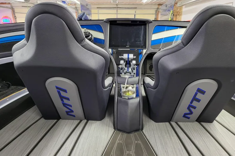 Slide: The Image of Interior of a 2019 MTI 340X boat with sleek seats and modern controls. - 6