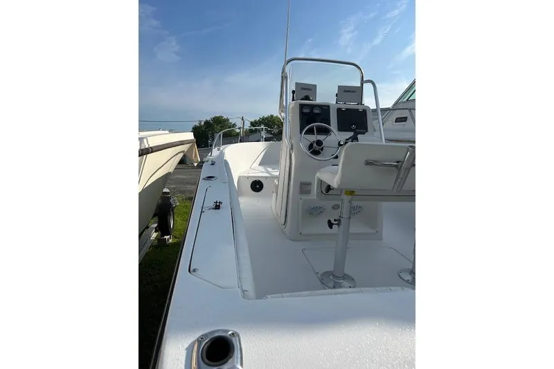 Slide: The Image of 2002 Seaswirl Striper 2101 Center Console boat with steering wheel and controls, docked outdoors. - 10