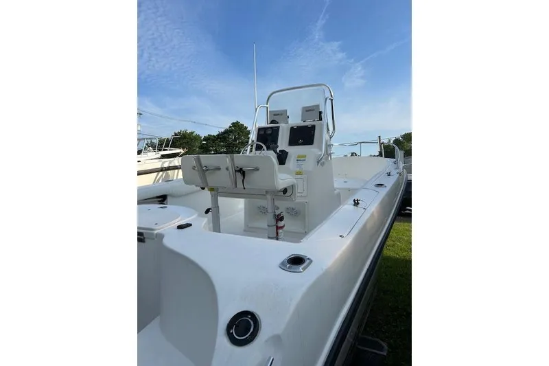 Slide: The Image of 2002 Seaswirl Striper 2101 Center Console O/B boat with open deck and control panel. - 5
