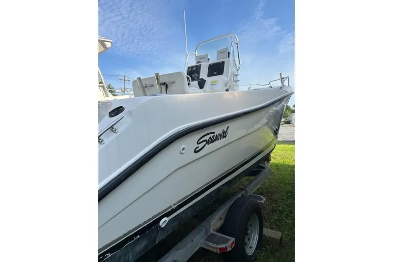 Slide: The Image of 2002 Seaswirl Striper 2101 Center Console boat on trailer, side view. - 6