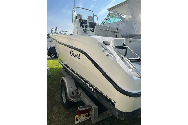 Slide: The Image of 2002 Seaswirl Striper 2101 Center Console boat on trailer, side view. - 9