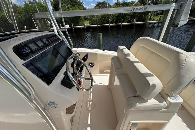 Slide: The Image of 2015 Grady-White Fisherman 257 boat interior with steering wheel and seating. - 11