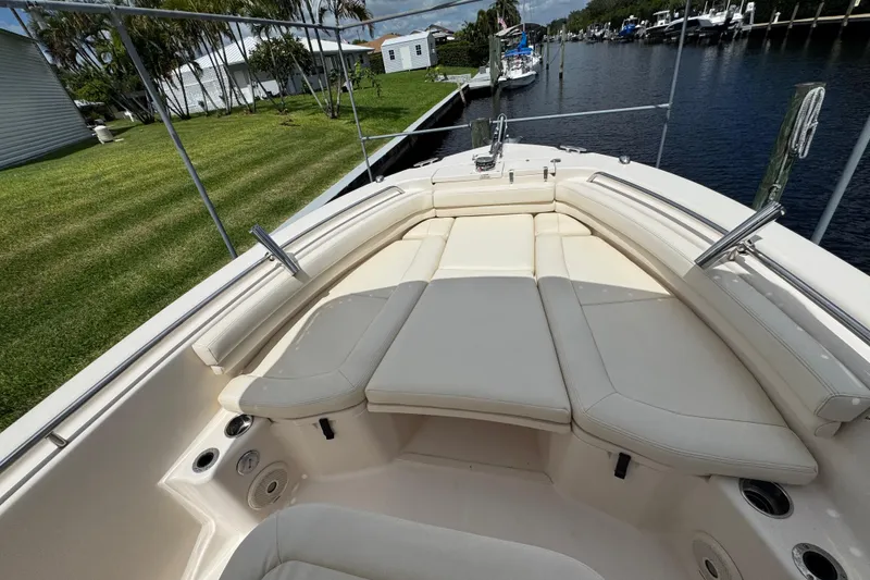 Slide: The Image of 2015 Grady-White Fisherman 257 boat with cushioned seating, docked by a canal. - 15