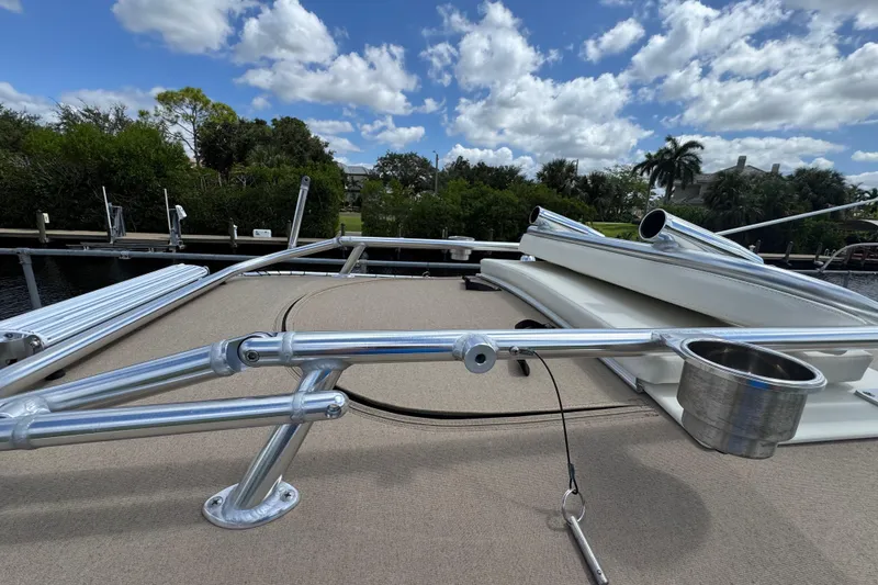 Slide: The Image of 2015 Grady-White Fisherman 257 boat deck with rod holders under a blue sky. - 18