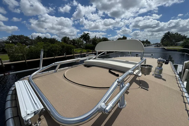 Slide: The Image of 2015 Grady-White Fisherman 257 boat deck with railing, under a partly cloudy sky. - 19
