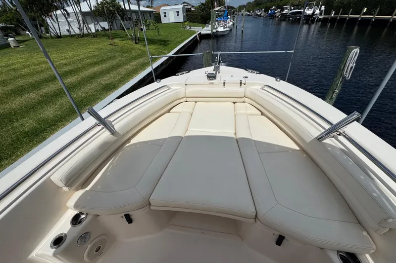 Slide: The Image of 2015 Grady-White Fisherman 257 boat with spacious seating, docked by a canal. - 21