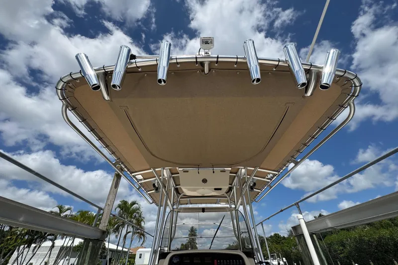Slide: The Image of 2015 Grady-White Fisherman 257 boat with rod holders under a clear blue sky. - 22