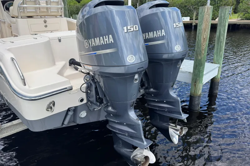 Slide: The Image of 2015 Grady-White Fisherman 257 with twin Yamaha 150 outboard motors docked by water. - 28