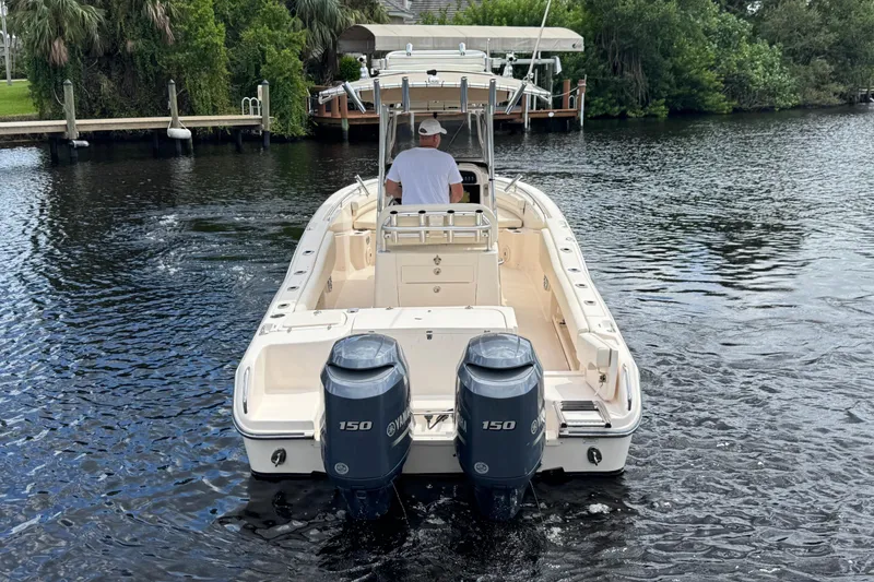 Slide: The Image of 2015 Grady-White Fisherman 257 boat with dual Yamaha 150 engines on a calm river. - 8