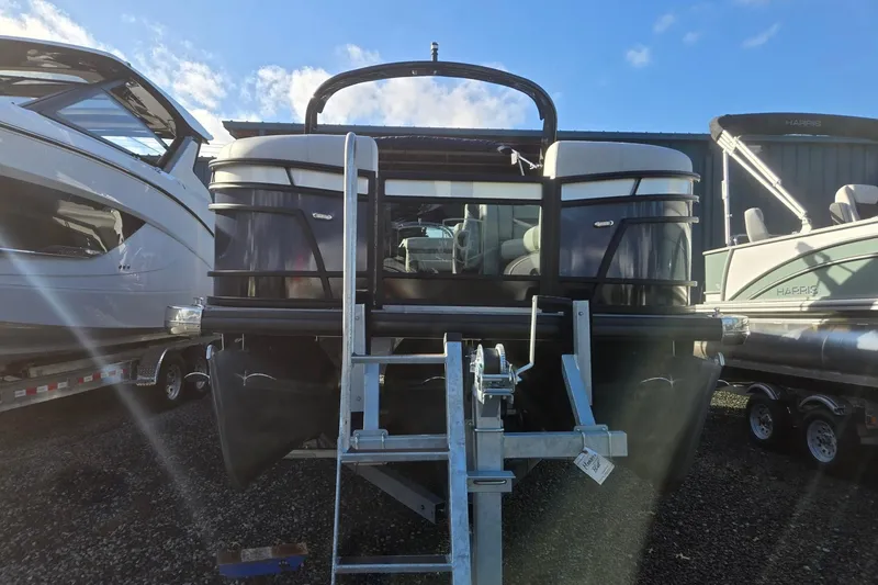 Slide: The Image of 2026 Godfrey Monaco 235 ULC pontoon boat on trailer, parked outdoors. - 1