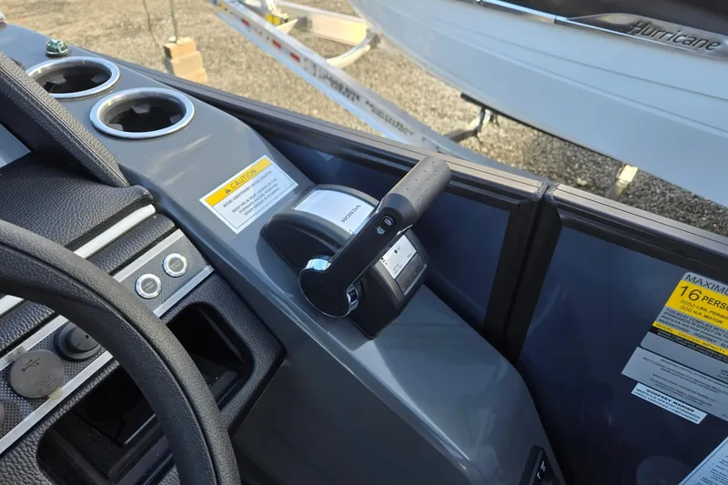 Slide: The Image of Control panel of 2026 Godfrey Monaco 235 ULC boat with throttle and cup holders. - 18