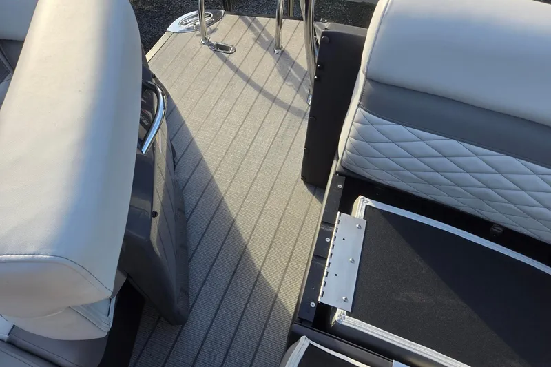 Slide: The Image of 2026 Godfrey Monaco 235 ULC boat interior with cushioned seating and textured flooring. - 26