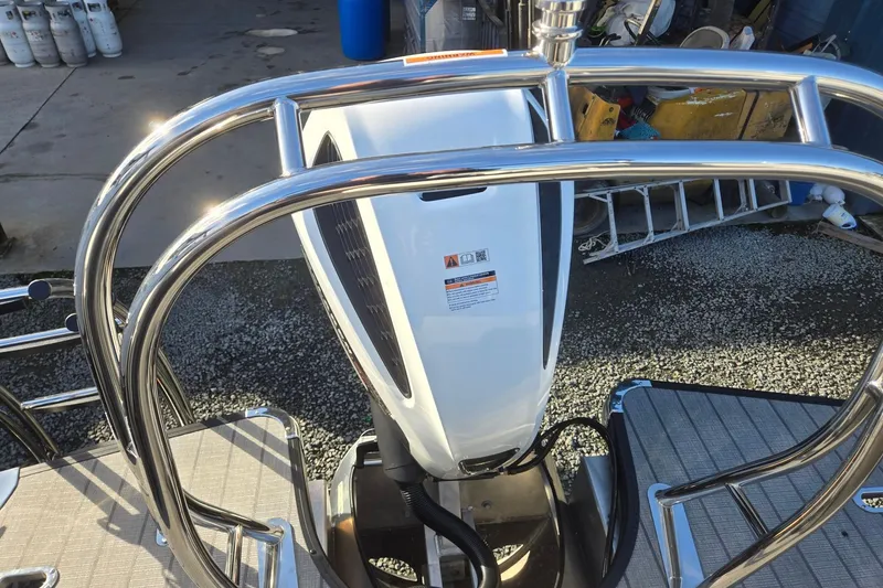 Slide: The Image of Close-up of 2026 Godfrey Monaco 235 ULC boat motor with chrome railing. - 27