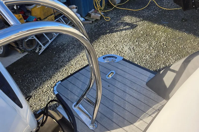 Slide: The Image of 2026 Godfrey Monaco 235 ULC boat deck with stainless steel railing and textured flooring. - 28