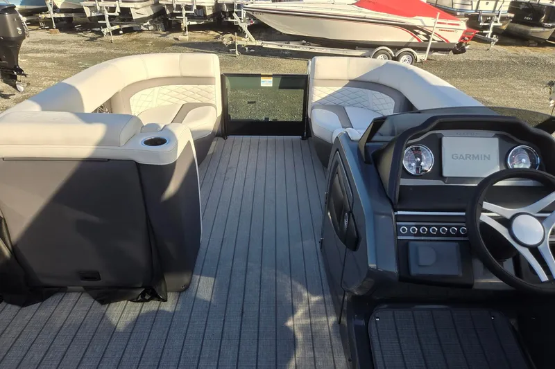 Slide: The Image of 2026 Godfrey Monaco 235 ULC boat interior with plush seating and Garmin dashboard. - 33