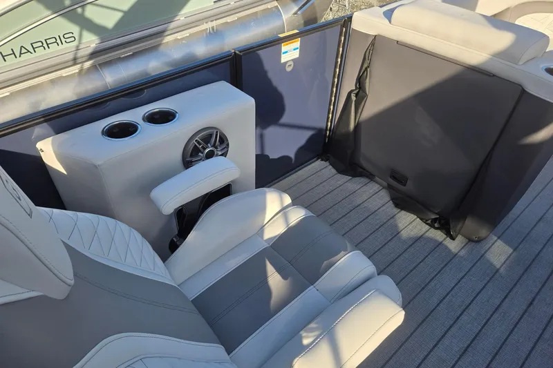 Slide: The Image of 2026 Godfrey Monaco 235 ULC boat interior with seating, cup holders, and speaker. - 34