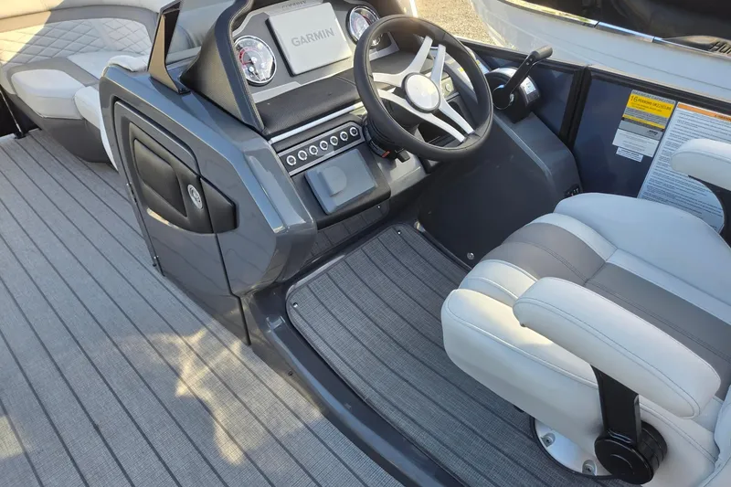 Slide: The Image of 2026 Godfrey Monaco 235 ULC boat interior with steering wheel and Garmin display. - 36