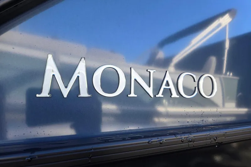 Slide: The Image of Monaco 235 ULC logo on 2026 Godfrey boat, close-up view. - 40