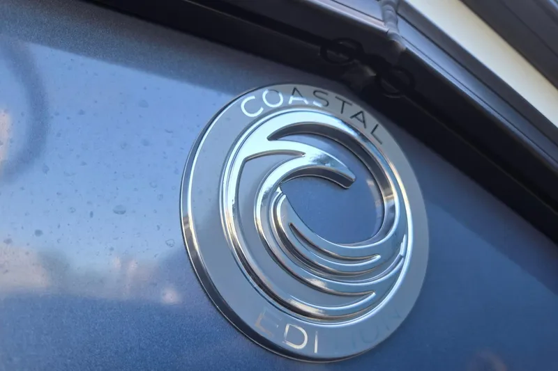 Slide: The Image of 2026 Godfrey Monaco 235 ULC Coastal Edition emblem on sleek blue surface. - 42