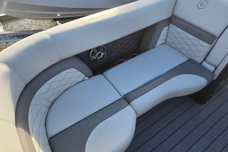 Slide: The Image of Luxurious seating on 2026 Godfrey Monaco 235 ULC boat with quilted upholstery and speaker. - 9