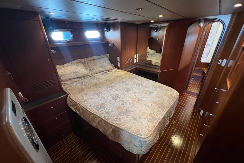 Slide: The Image of Luxurious cabin interior of 2002 Nordhavn 50 yacht with wood finishes and cozy bed. - 13