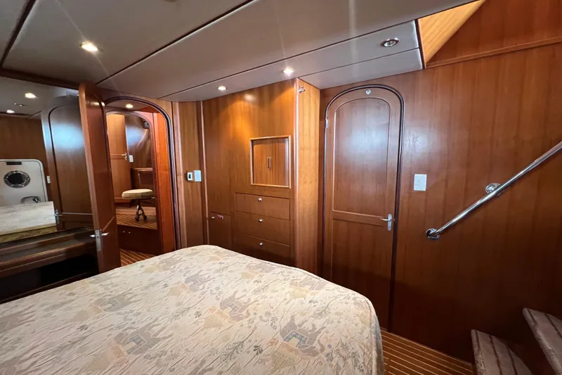 Slide: The Image of Luxurious wooden interior of 2002 Nordhavn 50 yacht cabin with bed and stairs. - 14