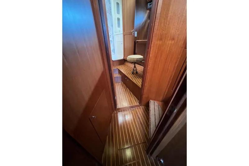 Slide: The Image of Interior of 2002 Nordhavn 50 yacht with wooden flooring and seating area. - 16