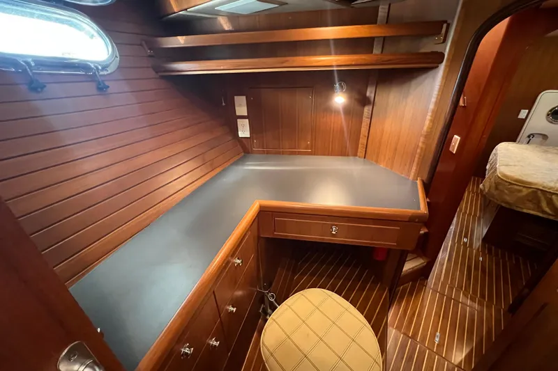 Slide: The Image of Luxurious wooden interior of 2002 Nordhavn 50 yacht with desk and seating area. - 18