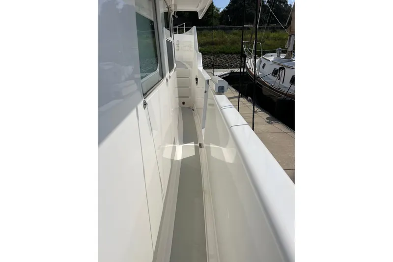 Slide: The Image of Side deck view of a 2002 Nordhavn 50 yacht, showcasing sleek white design. - 21