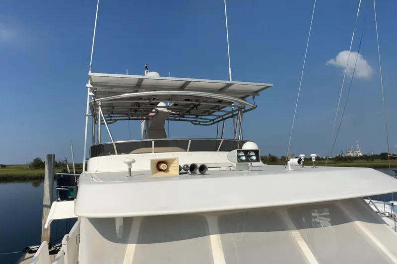 Slide: The Image of 2002 Nordhavn 50 yacht with solar panels and radar, docked on a sunny day. - 22